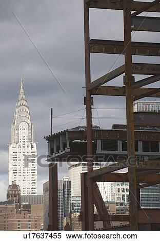 Stock Photography - USA, New York State, New York City, Construction site and Chrysler building in background. Fotosearch