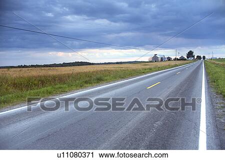 Stock Image - USA, New York State, Rural road. Fotosearch