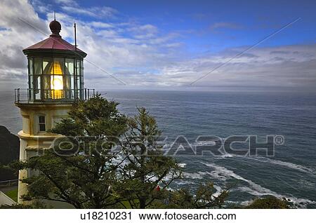Stock Image - USA, Oregon, Lane County, Lighthouse and sea. Fotosearch