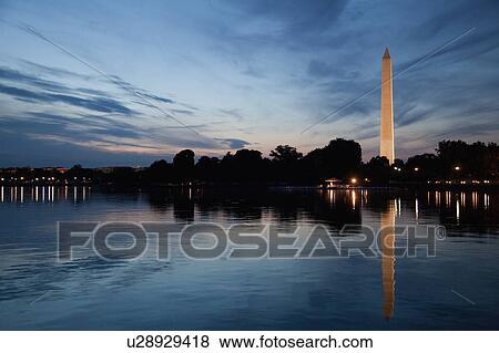 Stock Photo - USA, Washington DC, Washington Monument reflecting in water at dusk. Fotosearch