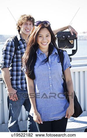 USA, Washington, Seattle, Couple standing by coin operated binoculars View Large Photo Image Stock Image - USA, Washington, Seattle, Couple standing by coin operated binoculars. Fotosearch