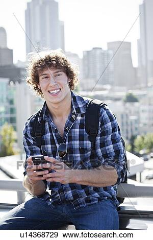 USA, Washington, Seattle, Man text messaging outdoors, skyline in background View Large Photo Image Stock Photo - USA, Washington, Seattle, Man text messaging outdoors, skyline in background. Fotosearch