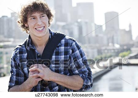 Stock Photo - USA, Washington, Seattle, Man with skyline in background. Fotosearch