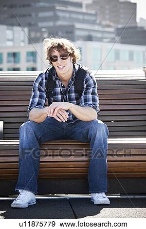 USA, Washington, Seattle, Young man sitting on bench View Large Photo Image Stock Photo - USA, Washington, Seattle, Young man sitting on bench. Fotosearch