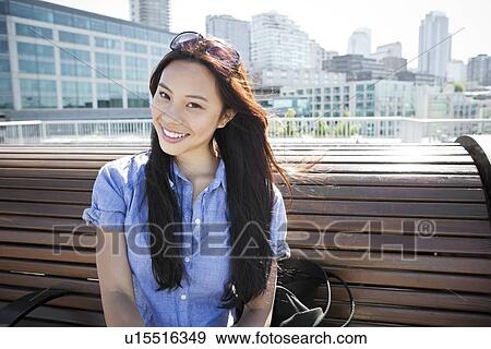 USA, Washington, Seattle, Young woman sitting on bench View Large Photo Image Stock Photo - USA, Washington, Seattle, Young woman sitting on bench. Fotosearch
