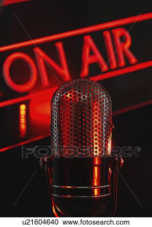 Stock Image - Vintage microphone and red on air neon, studio shot. Fotosearch