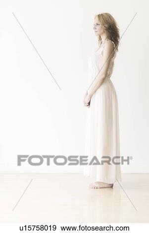 Stock Photo - Woman against white background, studio shot. Fotosearch