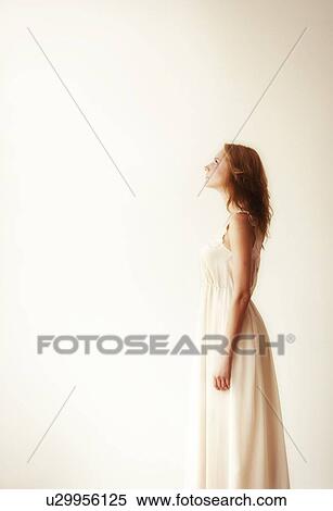 Stock Photography - Woman against white background, studio shot. Fotosearch