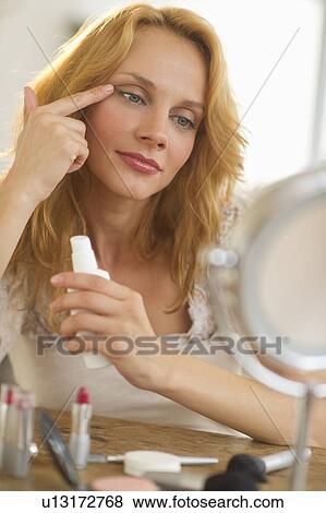 Woman applying make-up View Large Photo Image Stock Photo - Woman applying make-up. Fotosearch