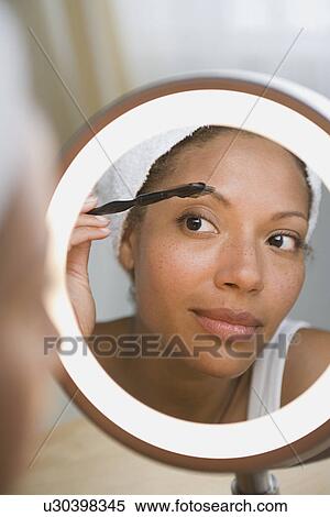 Woman brushing eyebrow View Large Photo Image Stock Photography - Woman brushing eyebrow. Fotosearch