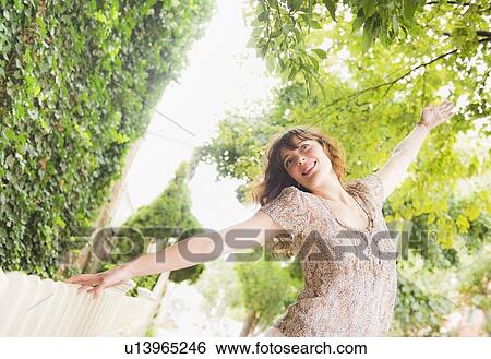 Woman dancing in park View Large Photo Image Stock Photograph - Woman dancing in park. Fotosearch