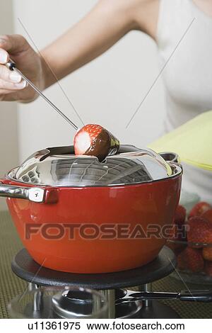 Woman dipping strawberries in chocolate mousse View Large Photo Image Stock Photography - Woman dipping strawberries in chocolate mousse. Fotosearch