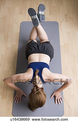 Woman doing push-ups View Large Photo Image Stock Photo - Woman doing push-ups. Fotosearch