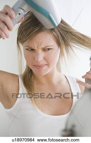 Picture - Woman drying hair. Fotosearch
