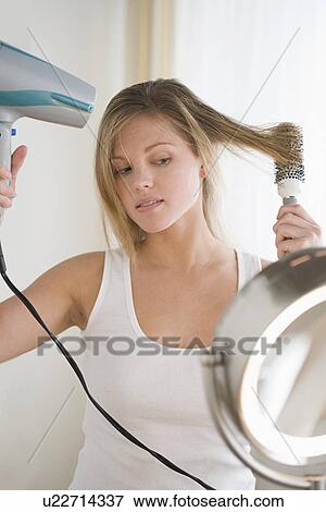 Woman drying hair View Large Photo Image Stock Photo - Woman drying hair . Fotosearch