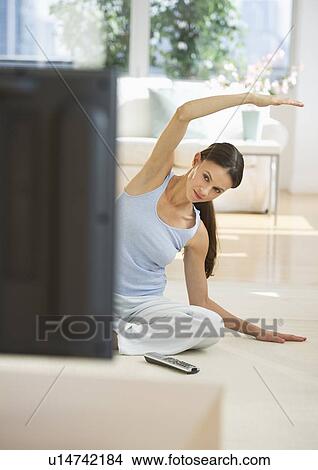 Woman exercising at home View Large Photo Image Picture - Woman exercising at home. Fotosearch