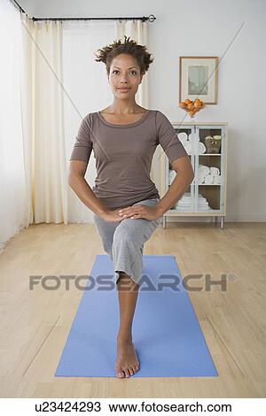 Woman exercising at home View Large Photo Image Stock Image - Woman exercising at home. Fotosearch