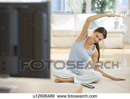 Woman exercising at home View Large Photo Image Stock Photo - Woman exercising at home. Fotosearch