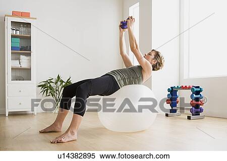 Woman exercising with fitness ball View Large Photo Image Stock Photography - Woman exercising with fitness ball. Fotosearch
