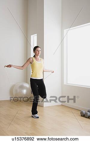 Woman exercising with jump rope View Large Photo Image Stock Image - Woman exercising with jump rope. Fotosearch