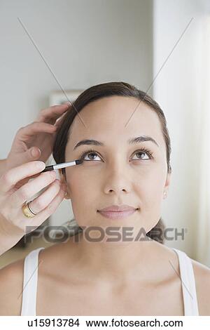 Woman having make-up applied View Large Photo Image Picture - Woman having make-up applied. Fotosearch