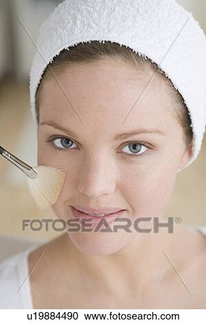 Stock Image - Woman having make-up applied. Fotosearch