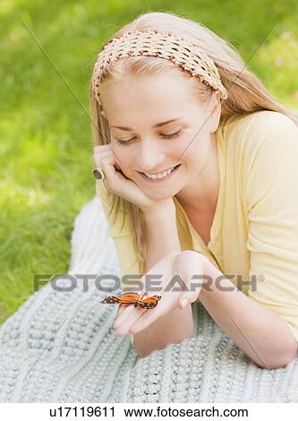 Woman holding butterfly on hand View Large Photo Image Stock Image - Woman holding butterfly on hand. Fotosearch