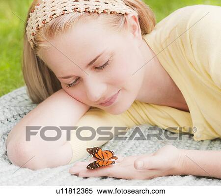 Woman holding butterfly on hand View Large Photo Image Stock Photography - Woman holding butterfly on hand. Fotosearch