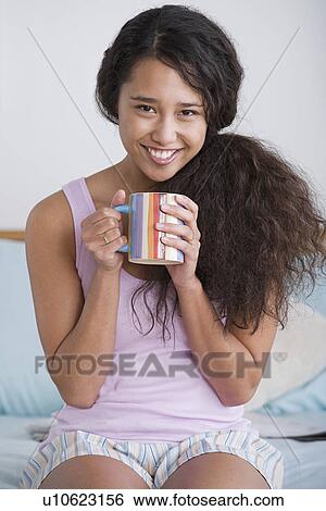 Stock Photograph - Woman holding mug. Fotosearch