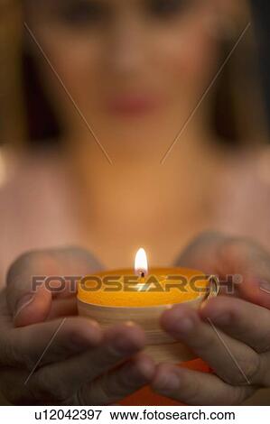Woman holding tealight View Large Photo Image Stock Photo - Woman holding tealight. Fotosearch