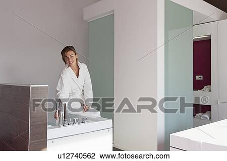 Woman in bathrobe pouring water into tub View Large Photo Image Stock Image - Woman in bathrobe pouring water into tub. Fotosearch