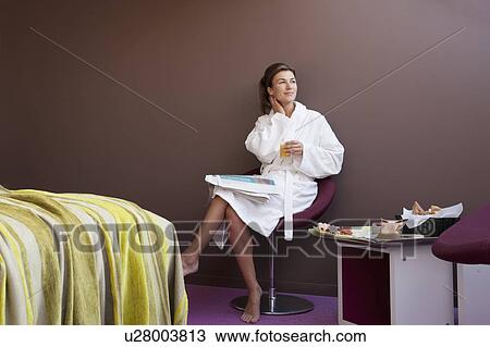 Woman in bathrobe sitting in bedroom View Large Photo Image Stock Image - Woman in bathrobe sitting in bedroom. Fotosearch
