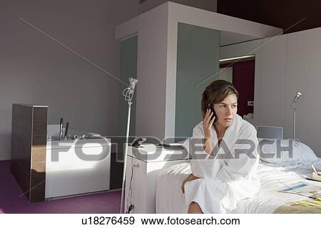 Woman in bathrobe sitting in bedroom View Large Photo Image Stock Photo - Woman in bathrobe sitting in bedroom. Fotosearch