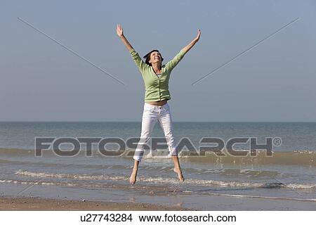 Woman jumping on beach View Large Photo Image Picture - Woman jumping on beach. Fotosearch