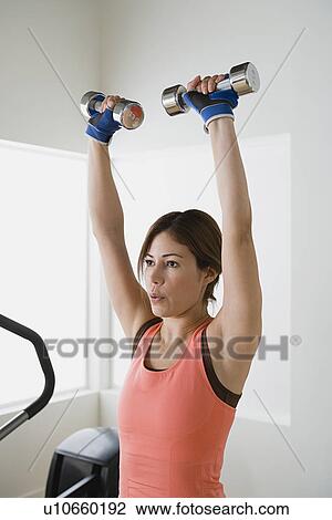 Woman lifting dumbbells View Large Photo Image Stock Image - Woman lifting dumbbells. Fotosearch