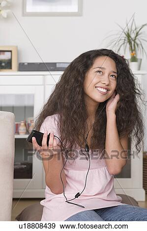 Woman listening to mp3 player View Large Photo Image Stock Photo - Woman listening to mp3 player. Fotosearch