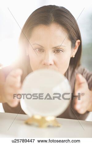 Woman looking into crystal ball View Large Photo Image Stock Photo - Woman looking into crystal ball. Fotosearch