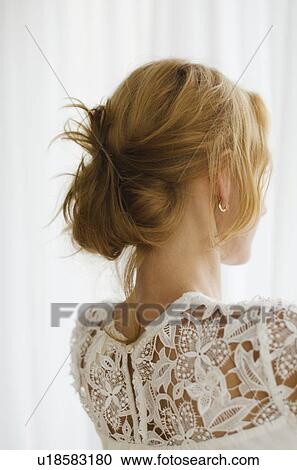 Stock Image - Woman looking out window. Fotosearch