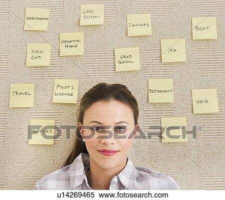 Stock Photography - Woman lying on carpet with adhesive notes around head. Fotosearch