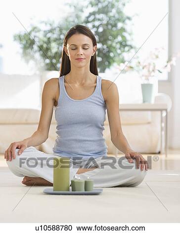 Woman meditating at home View Large Photo Image Stock Image - Woman meditating at home. Fotosearch