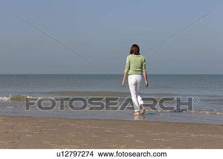 Picture - Woman on beach. Fotosearch
