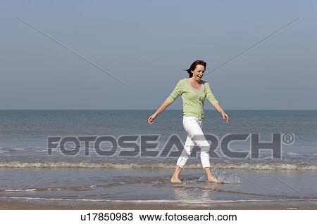 Stock Image - Woman on beach. Fotosearch