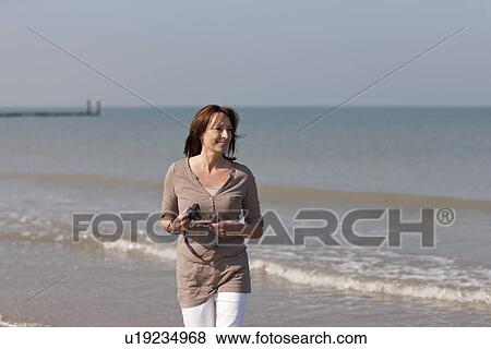 Stock Photo - Woman on beach. Fotosearch