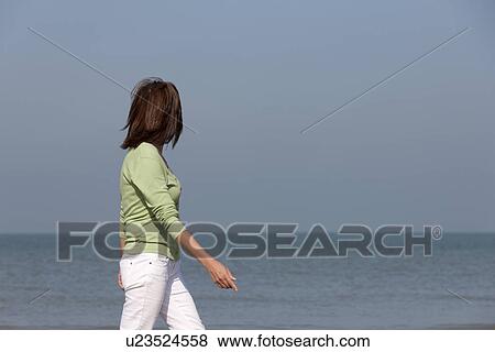 Stock Photo - Woman on beach. Fotosearch