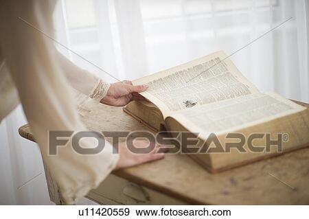 Stock Photo - Woman reading antique book. Fotosearch