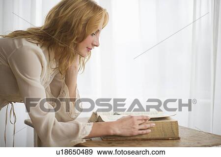 Woman reading antique book View Large Photo Image Stock Photo - Woman reading antique book. Fotosearch
