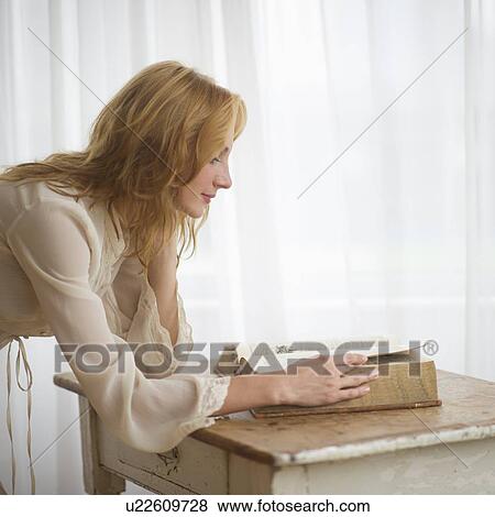 Stock Photo - Woman reading antique book. Fotosearch