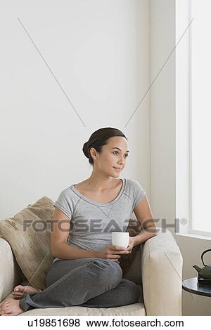 Woman relaxing at home View Large Photo Image Stock Photo - Woman relaxing at home. Fotosearch