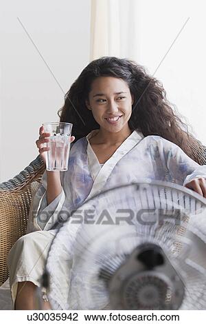 Stock Image - Woman relaxing in chair. Fotosearch