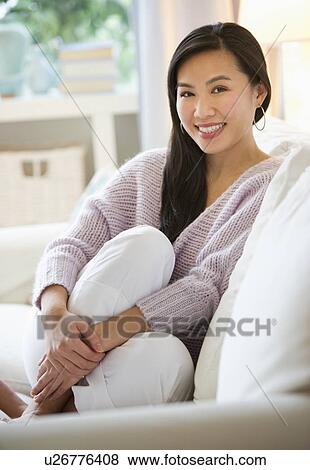 Stock Photo - Woman relaxing on sofa. Fotosearch